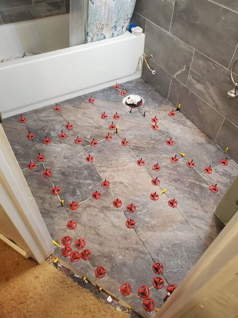 Bathroom floor tile installation by Ian Smart Construction